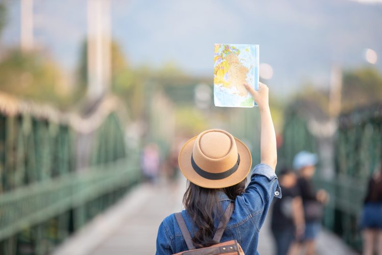 Female tourists on hand have a happy travel map. Female tourists on hand have a happy travel map.