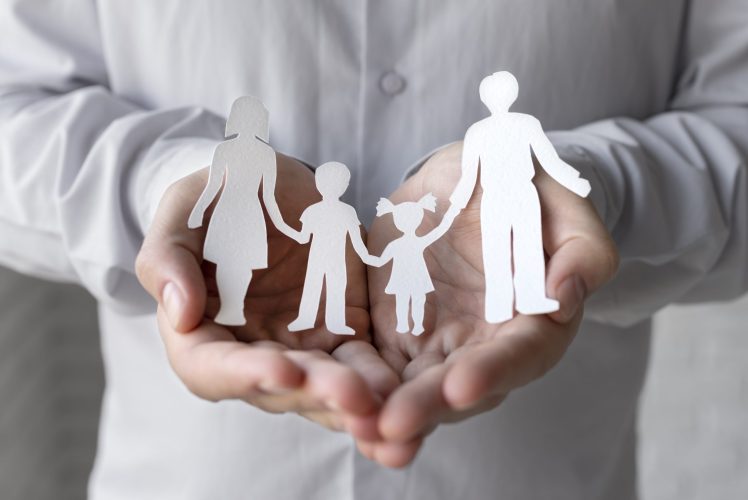 hands-holding-paper-people-close-up