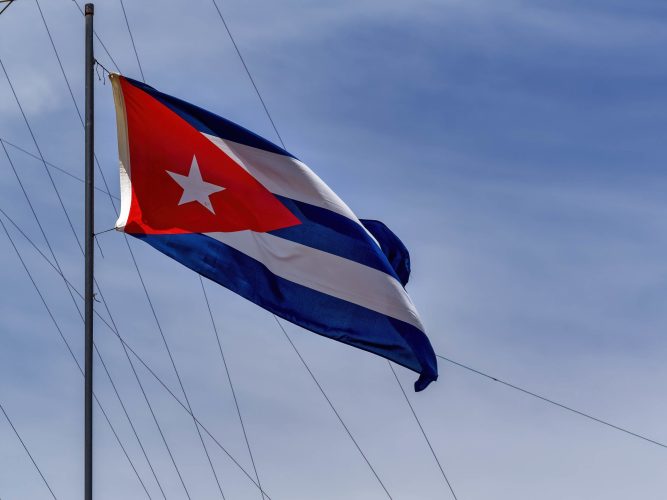 A low angle shot of the national flag of Cuba on a flagpole