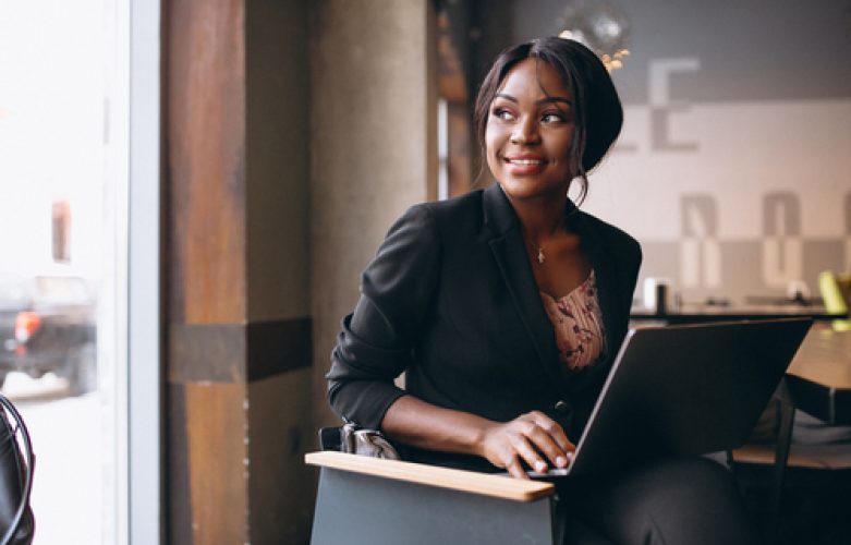 African american business woman working on a computer in a bar
